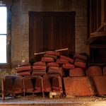 Stage with seats piled in the corner