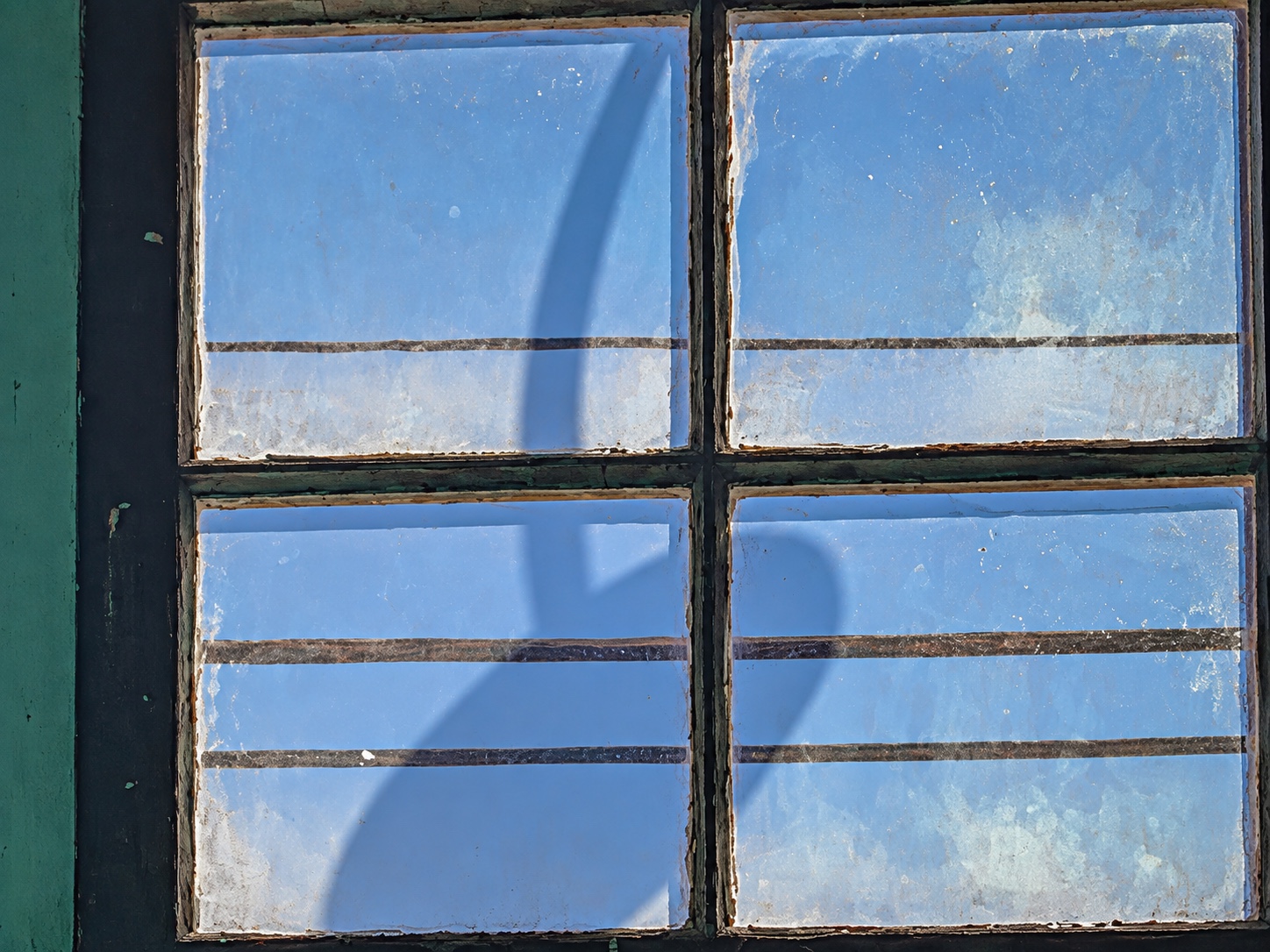 Light fixture shadow on a window glass