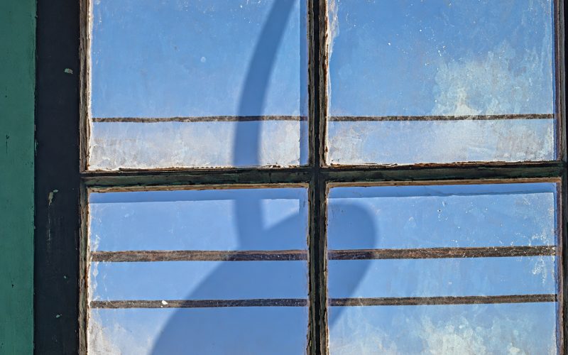 Light fixture shadow on a window glass